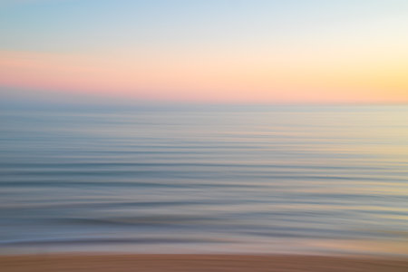 Abstract motion blur background. Beautiful sunset over the sea. Soft focus.の写真素材