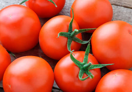 Tomatoes on a wooden tableの写真素材