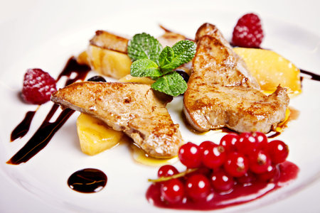 Chicken steak with fruits and berries served on plate