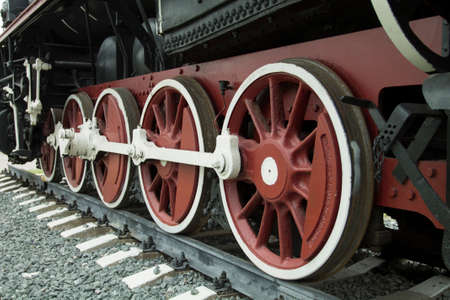 Closeup shot of wheels of retro train standing on the railway.の写真素材
