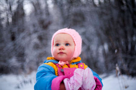 Portrait of a little girl with blush on cheeks from cold weather.の写真素材