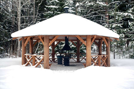 Big wooden summerhouse with hearth for making grill is empty for winter.の写真素材