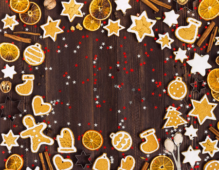 Gingerbread cookies christmas new year oranges cinnamon on wooden table with copyspace. Festive sweet pastry delicious food. Various cookies gingerbread man star heart christmas ball sockの写真素材