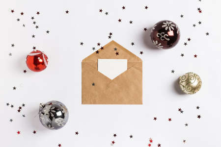 Christmas greeting card envelope decoration composition balls glitter stars on white festive table isolated. New year winter holiday xmas. Top view flat lay copy spaceの写真素材