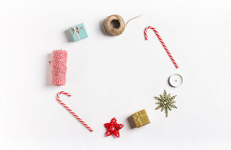 Christmas decoration composition gift box star candle ribbon candy cane on white festive table isolated. New year winter holiday xmas. Top view flat lay copy spaceの写真素材