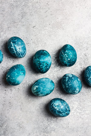 Easter eggs painted by hand in blue color on light background. Chicken eggs catholic and orthodox easter holidayの写真素材