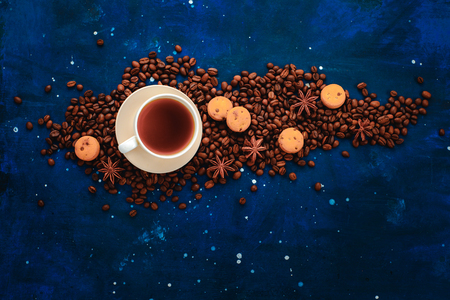 Frame with coffee cup, chocolate chip cookies and scattered coffee beans. Top view hot drink photography with copy space.の写真素材