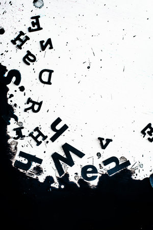 Scattered letters in blurring spilled ink. Creative writing concept ...