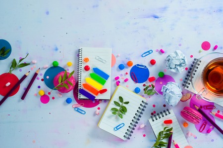 Colorful notebook with pencils and confetti on a light background with copy space. Pink and purple palette still life. Easy lifestyle conceptの写真素材