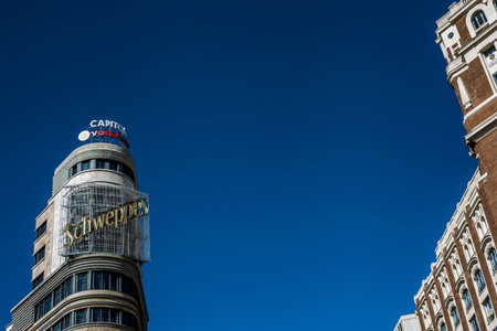building with schsweppes sign in gran via