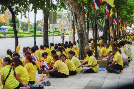 people sitting on the ground on the birthday of the king of Thailandのeditorial素材