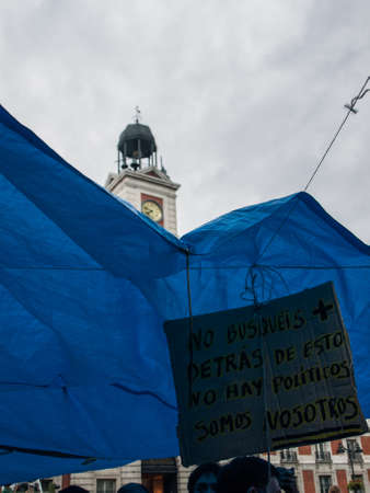 blue awning with banner at Puerta del Sol in Madrid. 15 M. Spainのeditorial素材