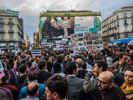advertising scaffolding at the Puerta del Sol on 15M with people, Madrid, Spainのeditorial素材