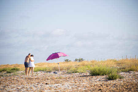 San Pedro del Pinatar, Murcia, Spain; 27 07 2020: couple hugging on the beachのeditorial素材