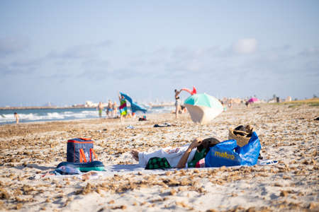 San Pedro del Pinatar, Murcia, Spain; 27 07 2020: person lying in towel on the beachのeditorial素材