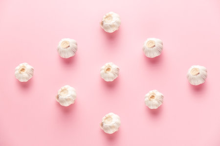 garlic composition on pink backgroundの写真素材