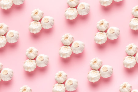 garlic on a pink background is made by a pattern for cookingの写真素材
