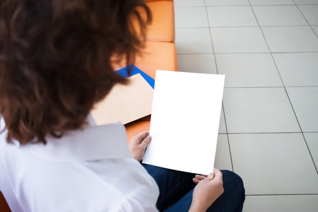 Empty space for the text. White sheet of paper in a hands.の写真素材