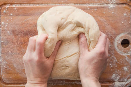 Bakery. Hands knead the dough.の写真素材
