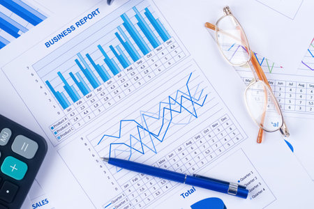 Flat lay. Business graph, report, calculator, pen and eyeglasses