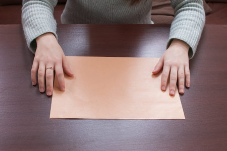 An empty space for the text. A blank envelope in the hands of a person.