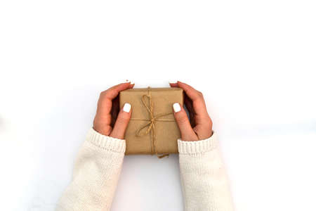 Woman hand are holding gift on the white background. top view. copy space.の写真素材