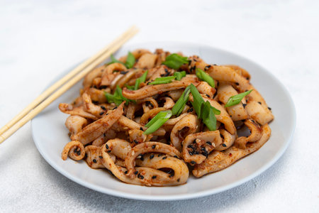Seafood salad of squid on the gray plate. Macro. On gray background. korean dish.asian dish.