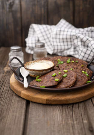 chicken liver bowls on a metal plate on a wooden background.の写真素材