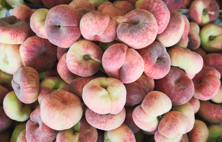 Ripe chinese flat peach fruits in a market.の写真素材