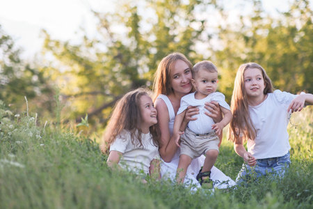 A beautiful Family Portrait captured amidst the serene beauty of Nature and greeneryの写真素材
