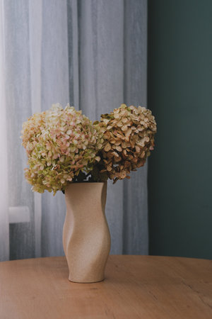 Stunningly Elegant Hydrangea Arrangement Presented Beautifully in a Curved Vaseの写真素材