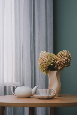 An Elegant and Charming Floral Arrangement Featuring a Beautiful Teapot and a Sugar Bowlの写真素材