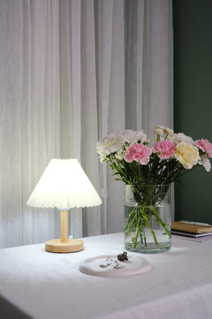 An Elegant Floral Arrangement Placed in a Cozy Room Setting That Invokes Warmth and Charm.の写真素材