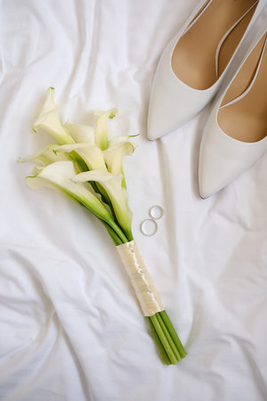 Delicate and Elegant Wedding Details Stunningly Beautiful Calla Lilies and Stylish Shoesの写真素材