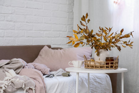A Cozy AutumnInspired Bedroom Featuring Stylish Decor and Rich, Warm Colors Throughoutの写真素材