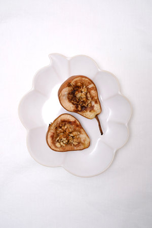 Sliced Pears Beautifully Presented on Decorative Plates, Finished with a Nut Mixture Toppingの写真素材
