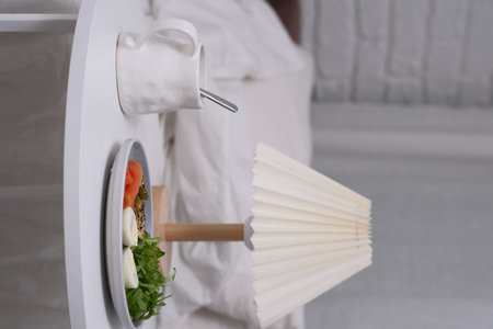 Enjoying a Cozy Breakfast in Bed and Warm Lamp for Comfort and Relaxation