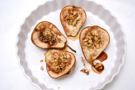 Sliced Pears Beautifully Presented on Decorative Plates, Finished with a Nut Mixture Toppingの写真素材