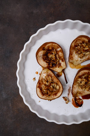 Sliced Pears Beautifully Presented on Decorative Plate, Finished with a Nut Mixture Toppingの写真素材