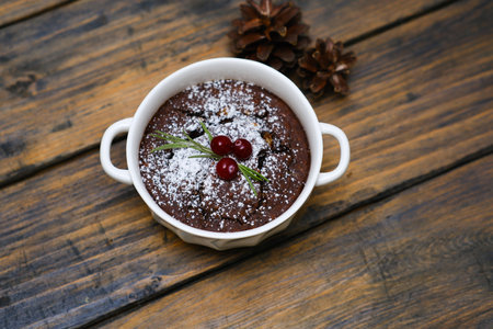 An Elegant Chocolate Dessert Beautifully Served in a White Bowl with a Garnish on Top on wooden table.の写真素材