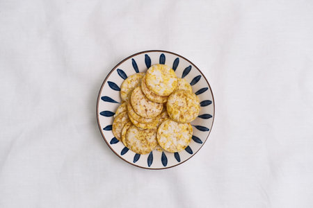 Enjoying Crispy Crackers on a white Background.の写真素材