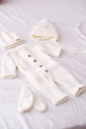 Cozy and Comfortable White Knitted Baby Outfit Complete with Hat and Socks Includedの写真素材