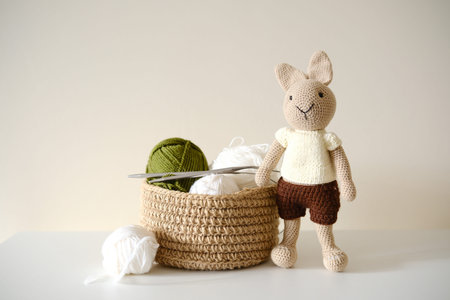 This adorable and delightful knitted rabbit toy comes beautifully packaged with yarn and a basket.の写真素材