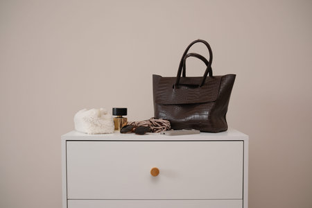 Chic handbag, woman accessories : parfum, cosmetic bag, sunglasses, skarf elegantly displayed on a...