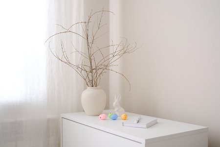 A beautifully minimalist springthemed decor that features elegant branches, a stylish vase, and...