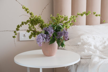 An Elegant and Beautiful Floral Arrangement in a Soft and Serene Bedroom Settingの写真素材
