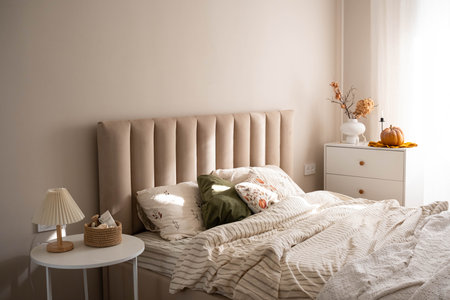 serene autumn bedroom with decor, cozy and serene autumn bedroom interior with textilesの写真素材