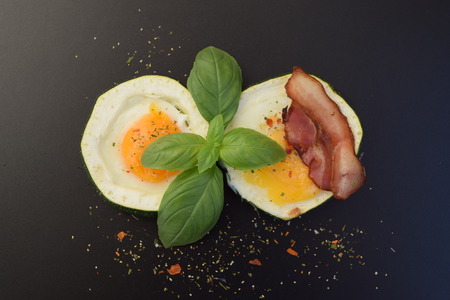 Scrambled eggs with zucchini on a black backgroundの写真素材