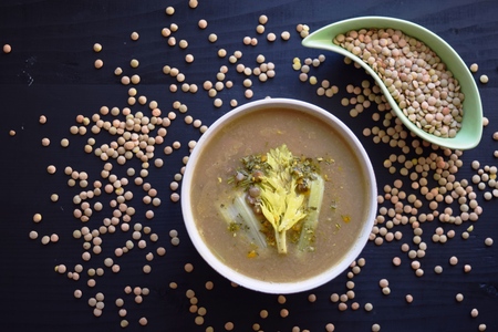 Cream lentil soup on black background, delicious vegetarian food. Top view.の写真素材