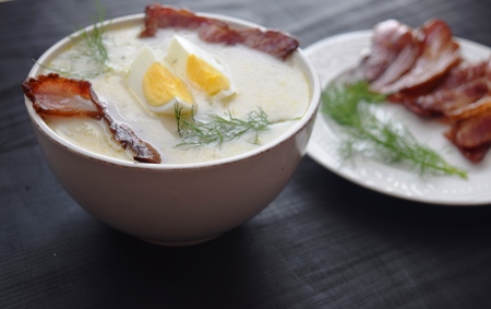 soup with dill, egg and bacon on a black background.の写真素材